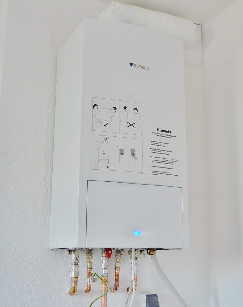 Las Vegas plumber installing modern tankless water heater system